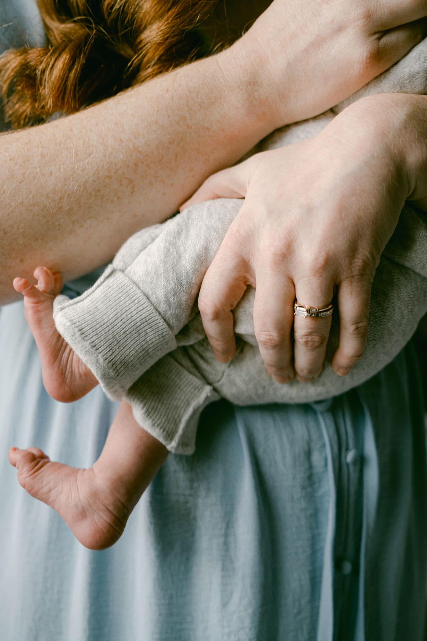 A close-up photography of mother holding newborn during their newborn photo session.